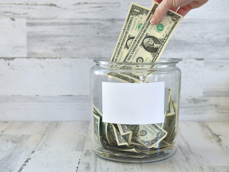 jar-of-money-cash-for-donation-fundraiser-fundraising-collection-hand-in-frame-blank-copy-space-q4yfubcqv57d96qjgkz6fo2j6xfi7m0gkmhz7vq9v4